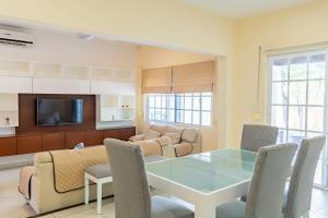 a living room with a glass table and chairs at Punta Piedra By Andiani in Cancún