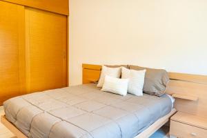 a bed with pillows on it in a room at Punta Piedra By Andiani in Cancún