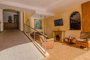 a living room with a staircase and a fireplace at Hotel Gaviota Vallarta in Puerto Vallarta