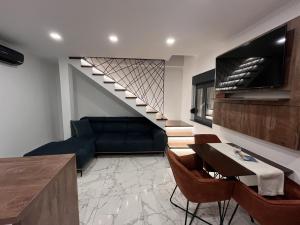 a living room with a staircase and a couch at Luxury Apartman Anđela in Banjol