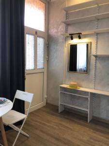 a room with a mirror and a desk and a chair at Lucky Space 1 Nice&Cosy Studio in Budva