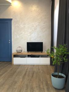 a living room with a flat screen tv on a white cabinet at Lucky Space 1 Nice&Cosy Studio in Budva