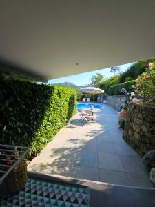a patio with a chair and a swimming pool at Orchidea in Beverino