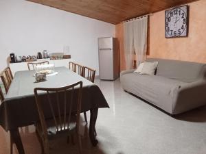 a living room with a table and a couch at La Mora in Castelvecchio Calvisio