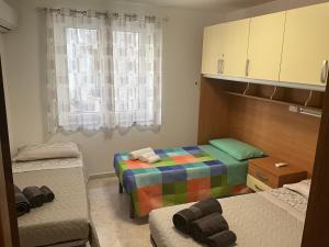 a small room with two beds and a window at Casa Mandoi in Dorgali +16 photos