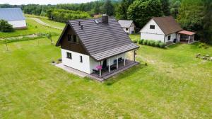 an aerial view of a small house in a field at Wigierska Piertówka in Leszczewo