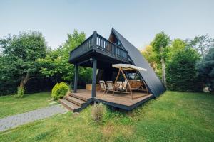 a tiny house with a deck and a porch at MC Sapanca Hotel in Sakarya