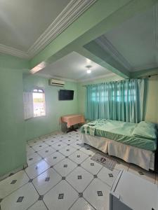 a bedroom with a bed and a table in it at Hotel Marajoara Breves in Breves