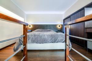 a bedroom with a bed and a wooden wall at The Lynx Konitsa in Konitsa