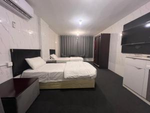 Postel nebo postele na pokoji v ubytování Al Majaridah Hotel