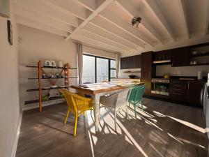 a kitchen with a table and chairs in a room at Beachview Apartment in Hout Bay