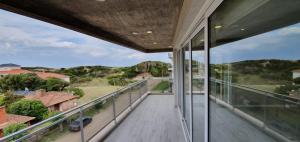 a balcony with a view of a house at Departamento edificio Arenas IV in Ostende
