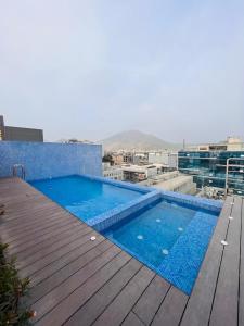 a swimming pool on the roof of a building at Monterrico Polo Aparts 19 - Dpto de Estreno con Balcon frente Embajada USA in Lima
