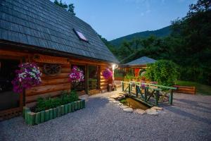 a store with flowers on the front of a building at Villa Bosnia in Donji Vakuf +25 photos