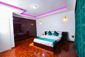 a bedroom with a bed with a green curtain at Luxury Exclusive 5Bedroom Home - Perfect for Families & Groups in Nairobi