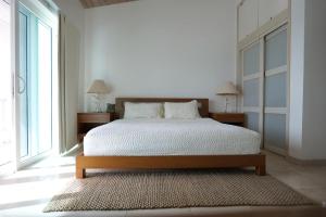 a bedroom with a bed and a large window at Whispering Palms Villa in Jolly Harbour in Jolly Harbour