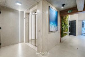 an empty hallway with a painting on the wall at Building with New Apartments 300m from the Beach - EEP in Guarapari