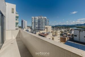a view of a city from the balcony of a building at Building with New Apartments 300m from the Beach - EEP in Guarapari