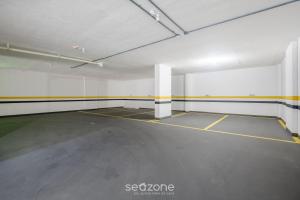 an empty parking garage with yellow and white walls at Building with New Apartments 300m from the Beach - EEP in Guarapari +96 photos