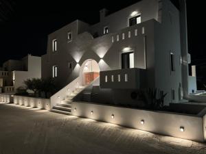 a building with lights on the side of it at night at Olive Garden Hotel in Agios Prokopios
