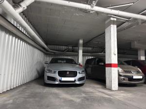 a parking garage with two cars parked in it at Cozy central apartment with FREE parking in Málaga