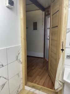 a bathroom with a door leading into a room at Letnisko na Pierkunowie in Giżycko