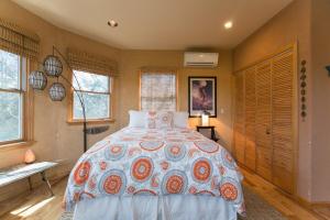 a bedroom with a bed in a room with windows at The Birdhouse Sweet suite! Downtown Roof top deck! in Asheville