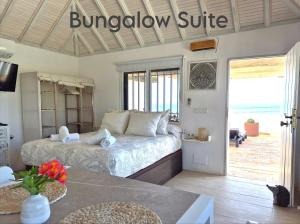a bedroom with a bed and a doorway with a balcony at Mandala Bungalows - Adults Only in Los Caños de Meca