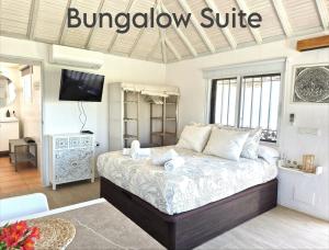 a bedroom with a bed with a window suite at Mandala Bungalows - Adults Only in Los Caños de Meca