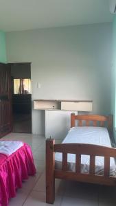 a bedroom with a wooden bed and a mirror at Casa Salinas in Salinópolis +22 photos