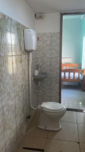 a bathroom with a toilet and a sink at Casa Salinas in Salinópolis