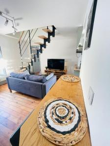 a living room with a table and a couch at Le Refuge de Ferrare - 6 people - Hyper center in Fontainebleau