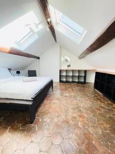 a bedroom with a large bed and skylights at Le Refuge de Ferrare - 6 people - Hyper center in Fontainebleau +18 photos