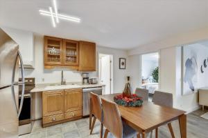 a kitchen with a wooden table and a dining room at Lang Farm Mountain View in Stowe