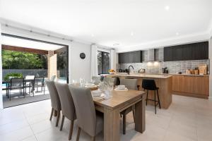 a dining room and kitchen with a table and chairs at Sunce Manyana Luxury home with pool and spa in Manyana