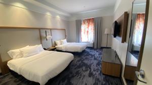 a hotel room with two beds and a television at Fairfield Inn and Suites New Buffalo in New Buffalo