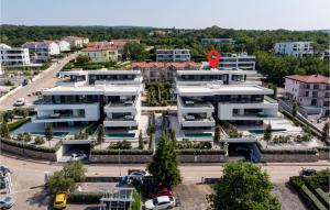 an apartment building with a red circle on top of it at Cozy Apartment In Malinska With Wifi in Malinska