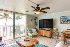 a living room with a flat screen tv at Beachfront Penthouse with 3 Lanais on Oahu! in Hauula