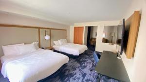 a hotel room with two beds and a television at Fairfield Inn and Suites New Buffalo in New Buffalo