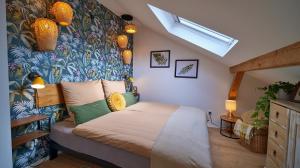 a bedroom with a bed with a colorful wall at Treetop Apartment - Schwarzwald und Schwäbische Alb in Eutingen +23 photos