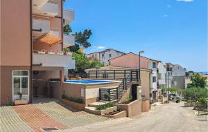 a city street with buildings and a swimming pool at Awesome Apartment In Baska Voda in Baška Voda