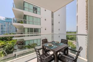 a balcony with a table and chairs and a building at Edificio Morros 3 in Cartagena de Indias