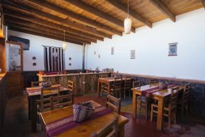 a dining room with wooden tables and chairs at Hostal Nuevo Amanecer in San Pedro de Atacama