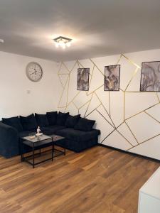 a living room with a couch and a table at MVPs Snug Urban Hideaway in Manchester