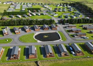 an aerial view of a parking lot with houses at Whitecairn Holiday Park in Glenluce