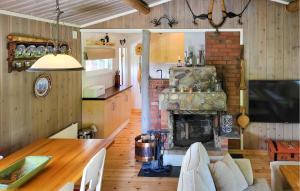 a kitchen and living room with a brick fireplace at 2 Bedroom Nice Home In Hafjell in Hafjell