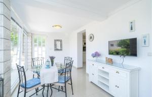 a dining room with a glass table and chairs at Amazing Home In Cavtat in Cavtat