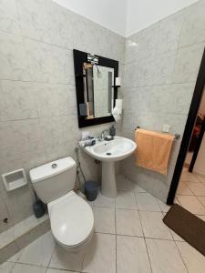 a bathroom with a white toilet and a sink at Alma Martil - Appart face à la plage - plage à 50m - Juste en face! in Martil