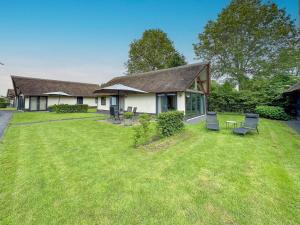 a house with a grass yard in front of it at Villa de Argento in Alphen