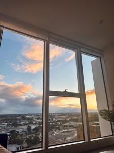 a window with a view of a city at Luxurious city view at Sydney Olympic Park in Sydney